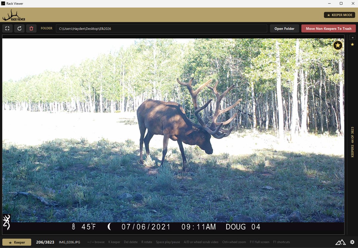 Rack Viewer with the keeper list collapsed so a bull elk trail-camera photo fills the window, the gold keeper star on the image, KEEPER MODE in the header, and 44 keepers of 3,823 on the slim side rail